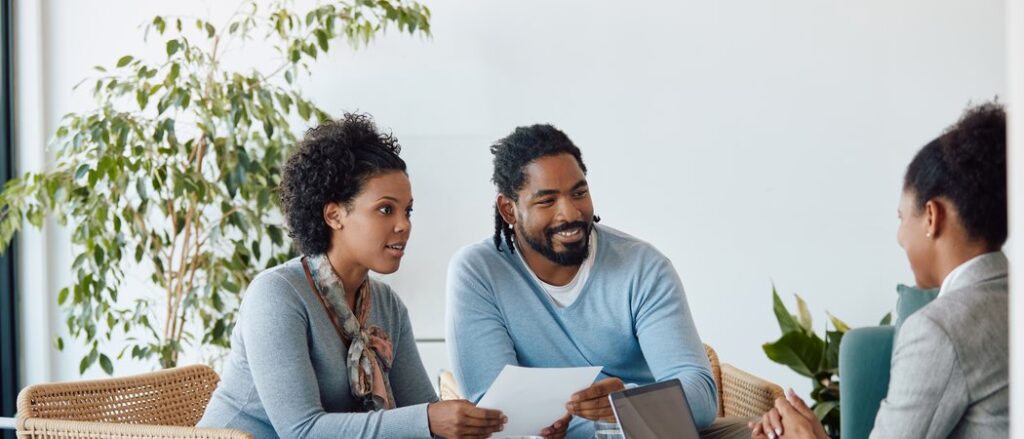 Couple discussing financial protection and insurance planning with a financial advisor