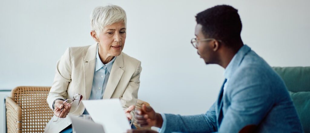 Senior couple reviewing estate planning documents with financial advisor